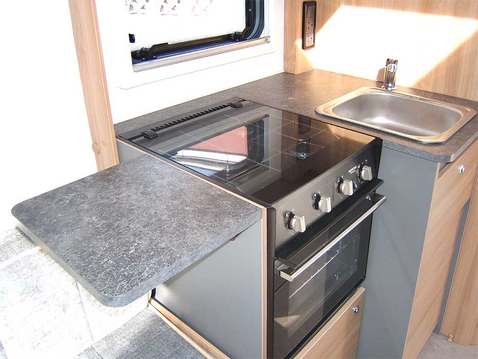 The kitchen has a worktop extension flap shown here in the up postion. It can be folded away when not needed.